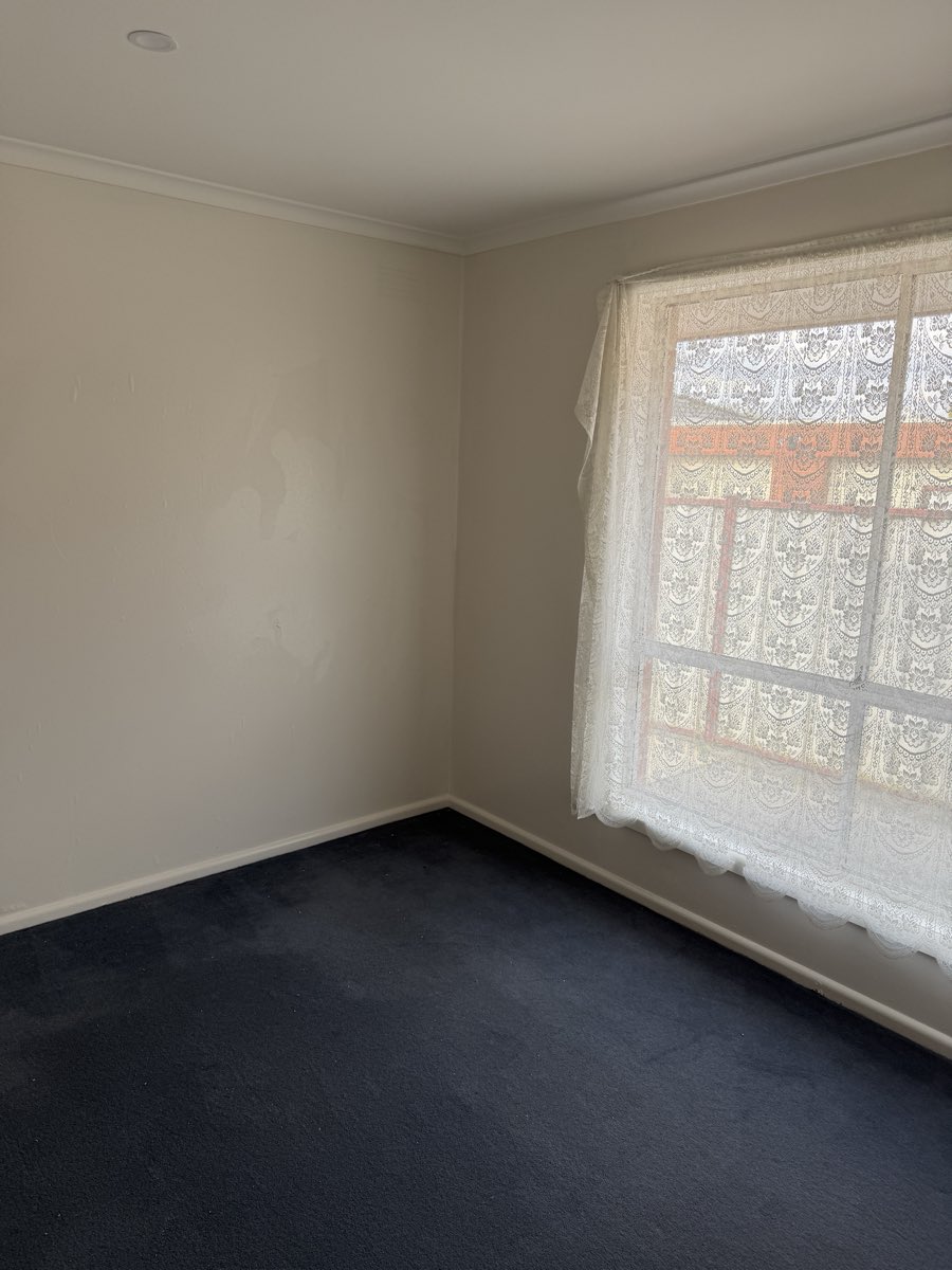 A broad, light-coloured interior wall is shown after repainting.