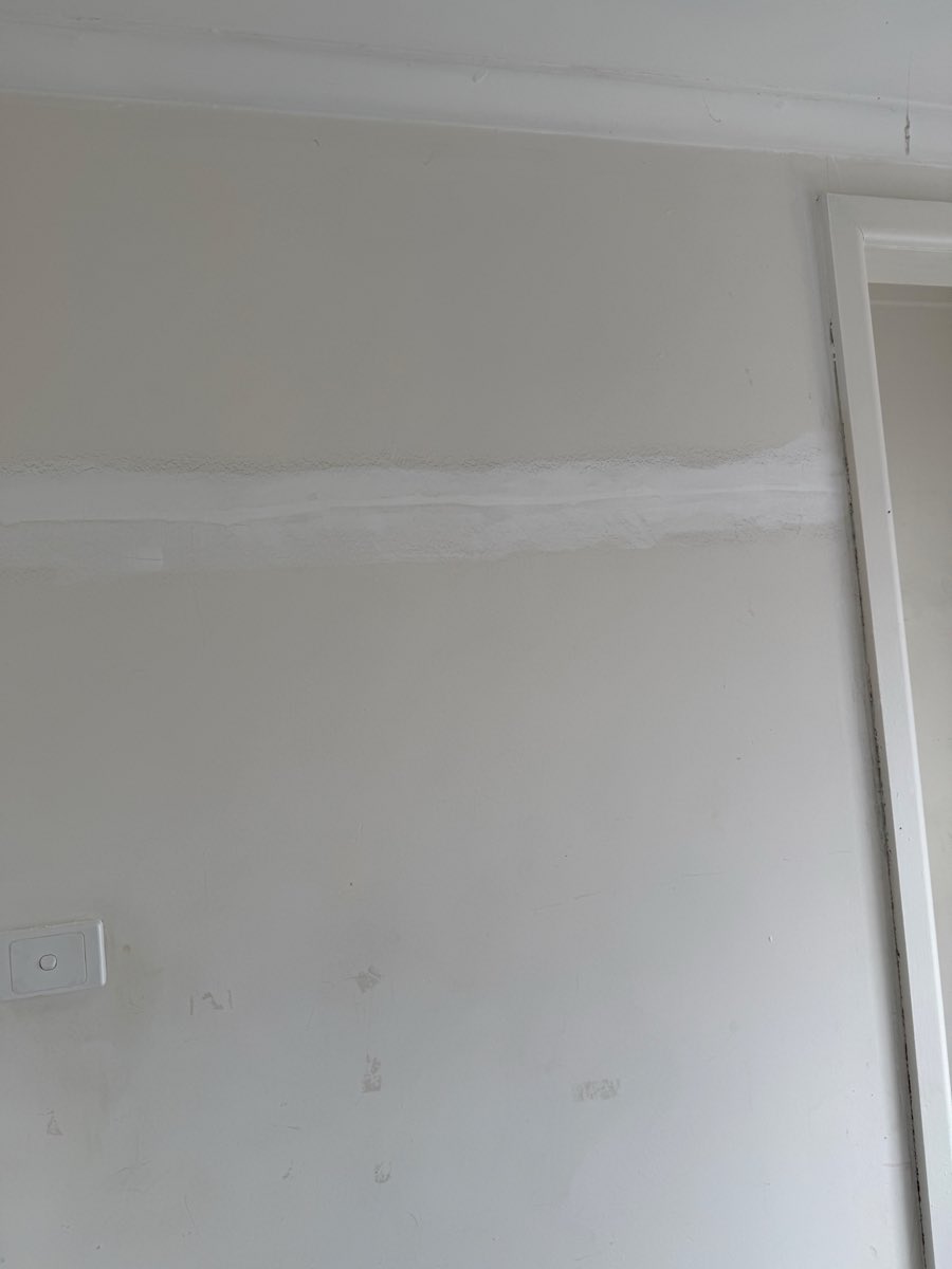 A broad horizontal filled line crosses an interior wall above small surface marks.